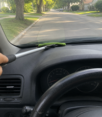 Reaches the impossible gap between dashboard and windshield